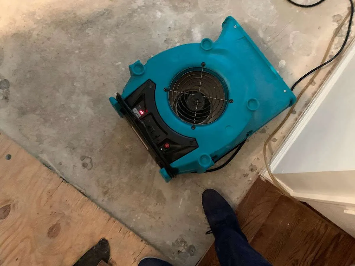 Air mover drying subfloor during Commercial Water Damage Restoration in University of California-Santa Barbara